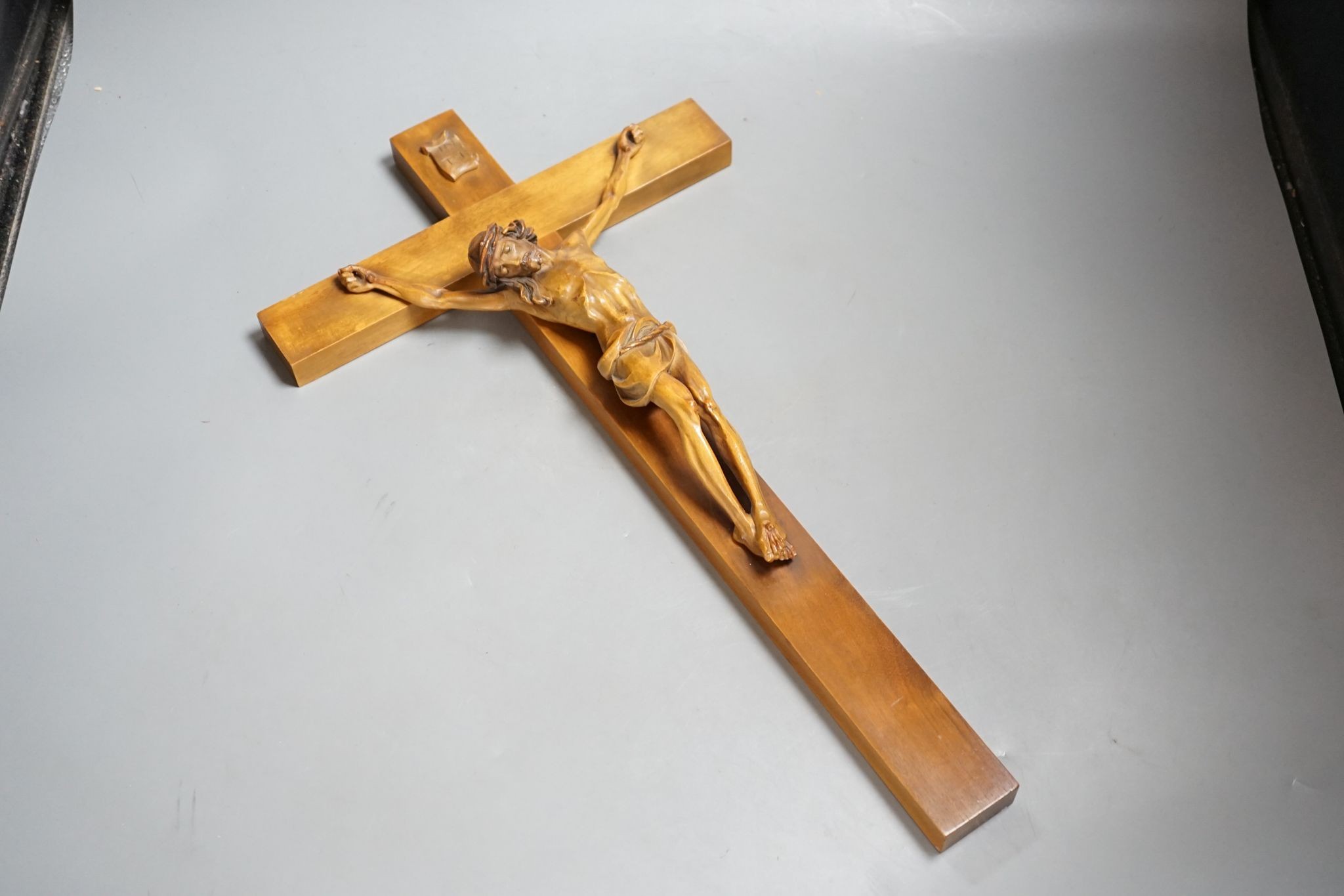 A carved crucifix and a framed metal Peruvian colonial crucifix, 50cm